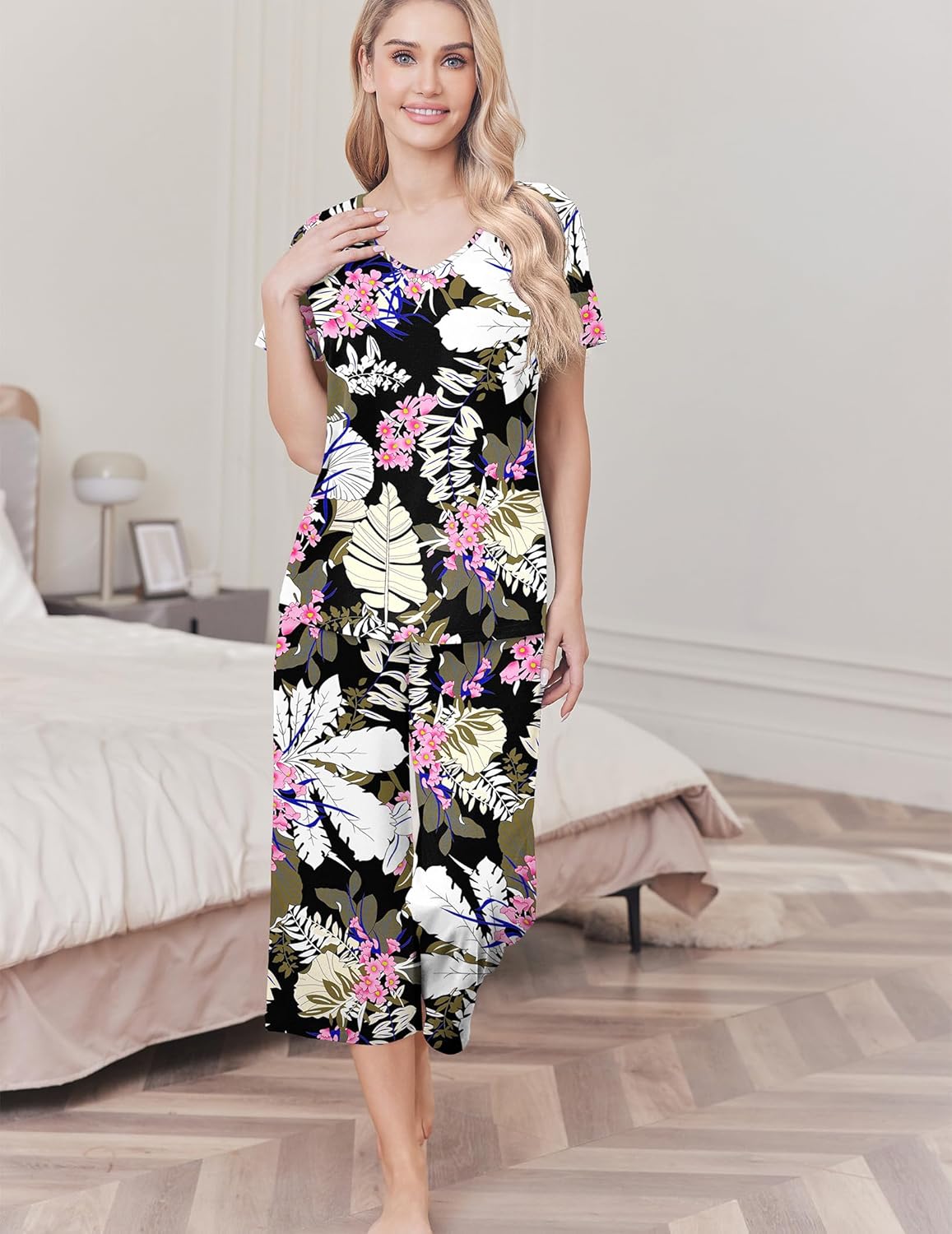 Women's cotton pajama set with black top and capri pants, pink and white floral print