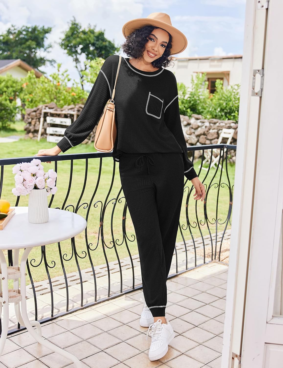 Black waffle knit lounge set: long sleeve top with pocket and cuffed drawstring pajama pants