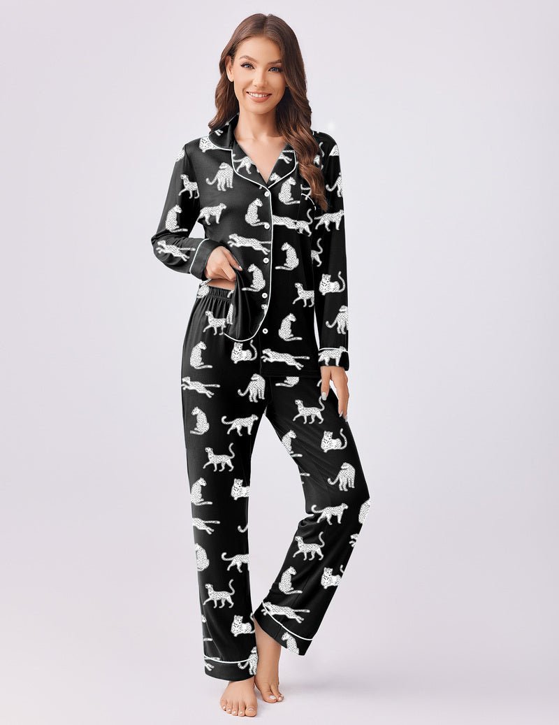 Black pajama set with scattered dog prints; button-front top with collar and long pants.