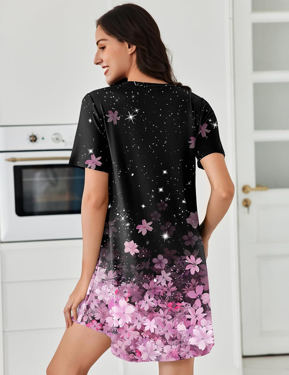 Black short-sleeve nightshirt dress with pink floral star print, back view