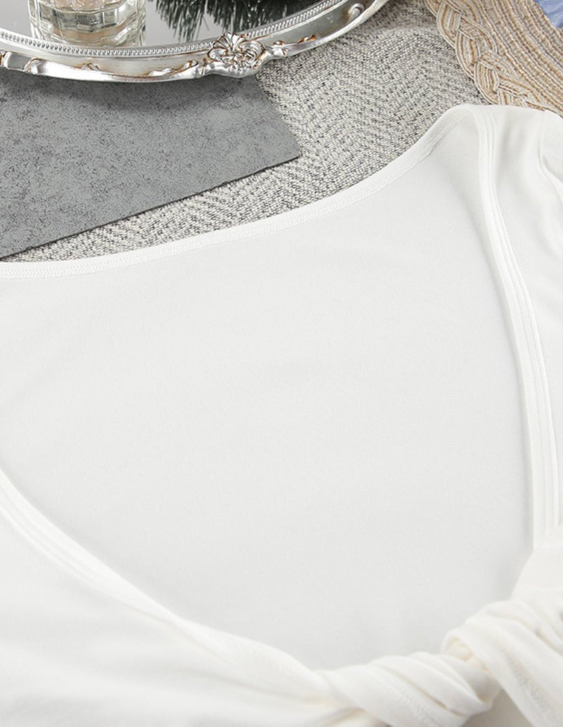 White camisole top with curved neckline and thin tie straps