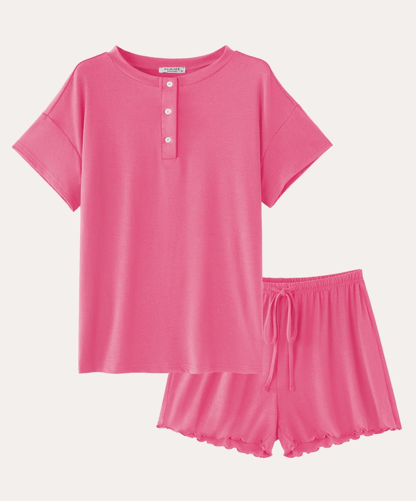Cotton pajama set in pink: short-sleeve henley top and drawstring sleep shorts.