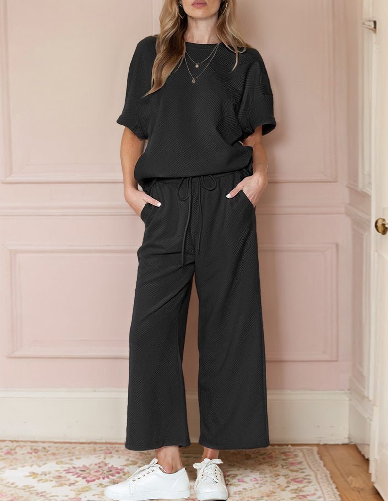 Black textured loungewear set, short-sleeve top and wide-leg pants with drawstring waist