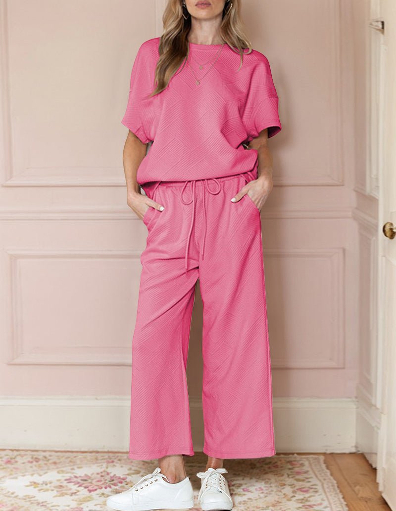 Pink textured loungewear set with short-sleeve top and wide-leg drawstring pants
