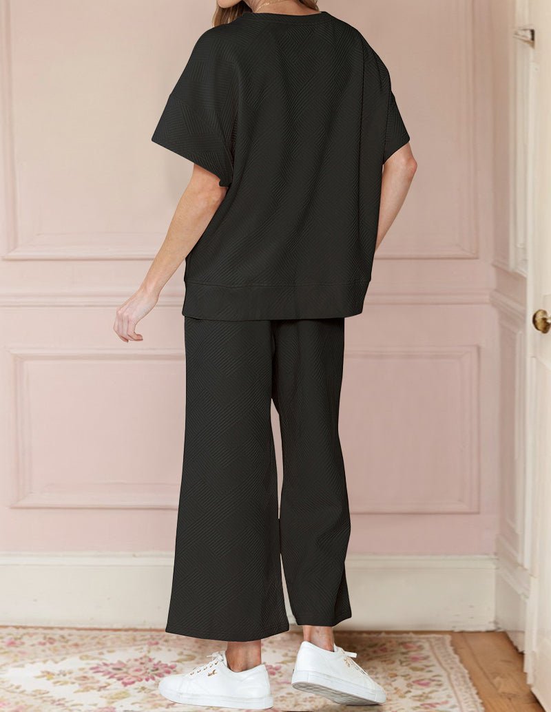 Black textured loungewear set, short-sleeve top and wide-leg pants, back view