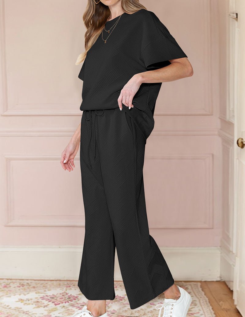 Black textured loungewear set with short-sleeve crew top and wide-leg pants