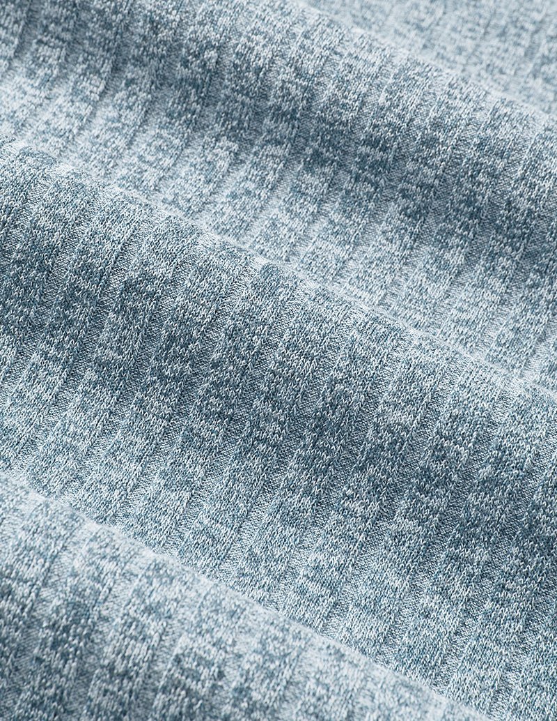 Light blue ribbed knit fabric close-up with textured stretch pattern