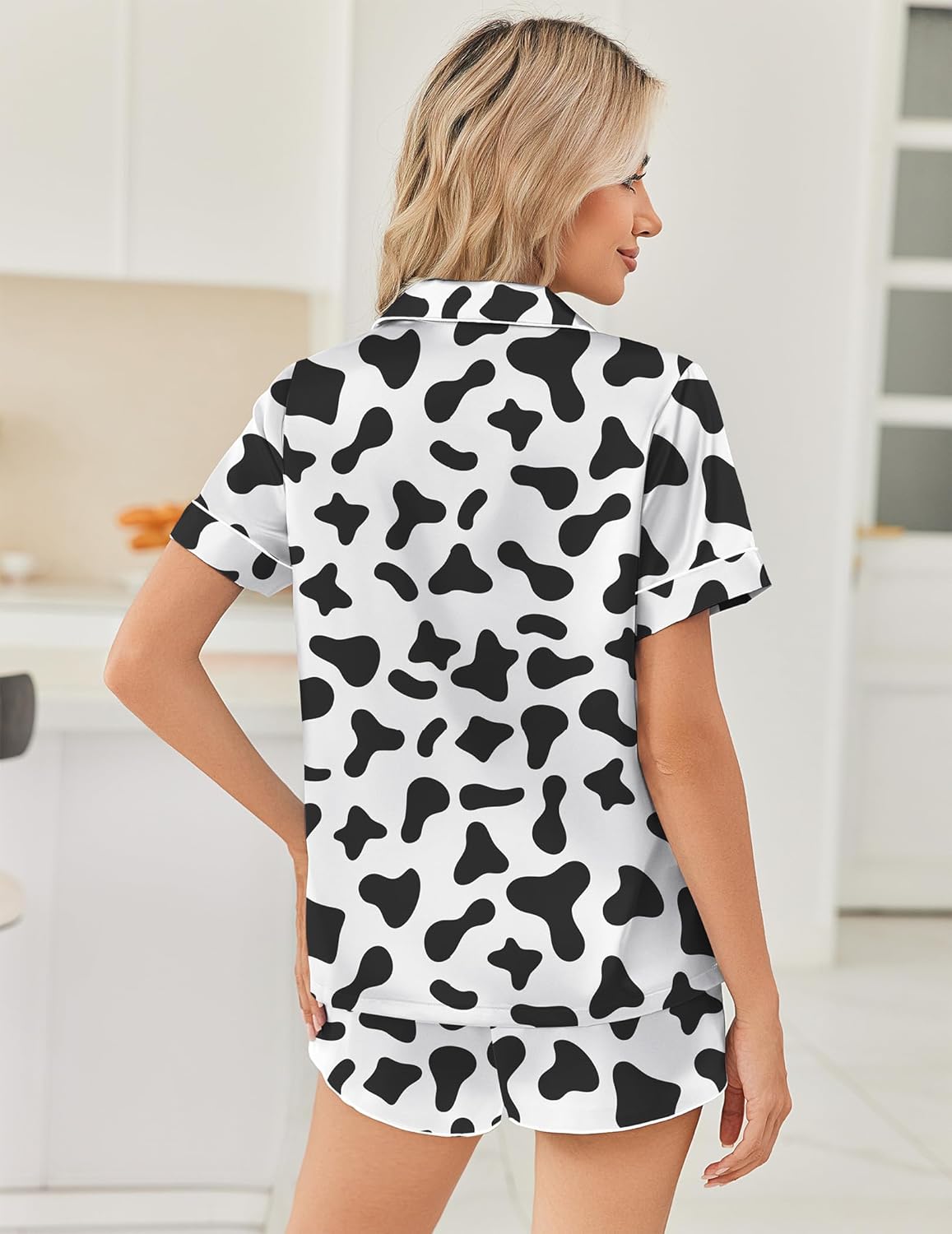 White-and-black cow-print satin pajama set, short-sleeve button-up and shorts, back view
