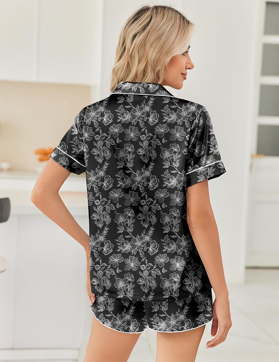 Back view of black satin pajama set with white floral print, button shirt and shorts
