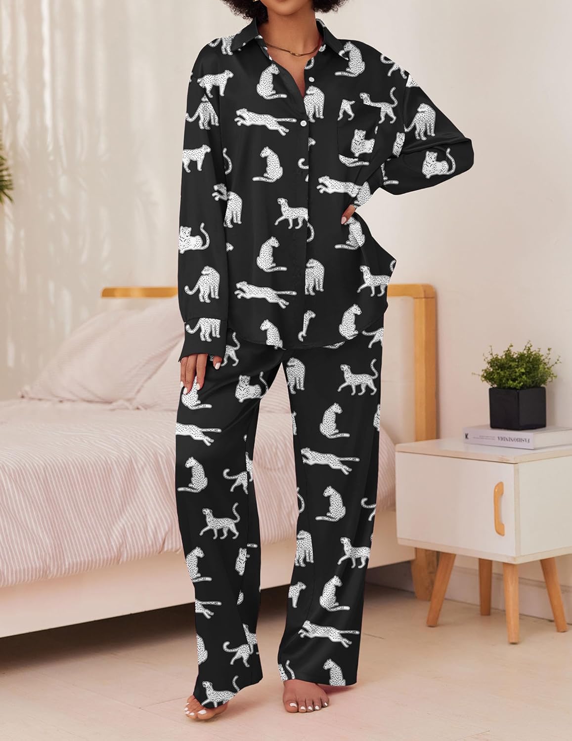 Black satin pajama set with white dog print, button-front top and long pants.