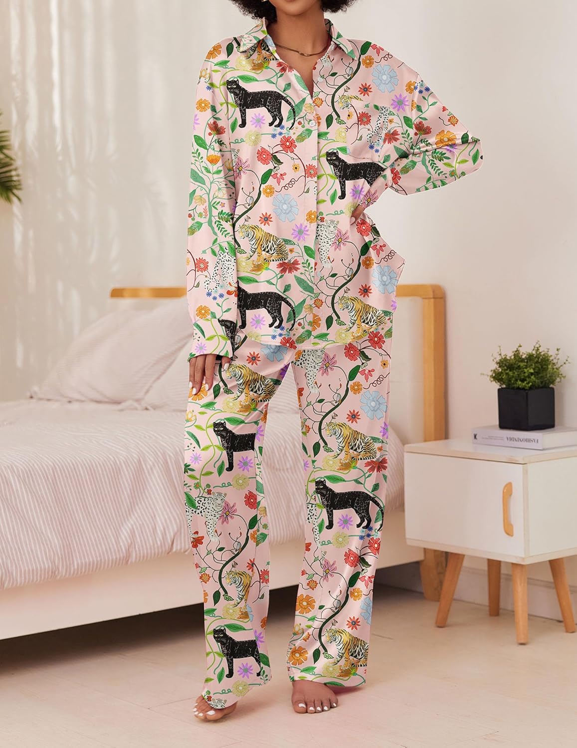 Light satin pajama set with colorful animal and floral print, button-front top and pants.