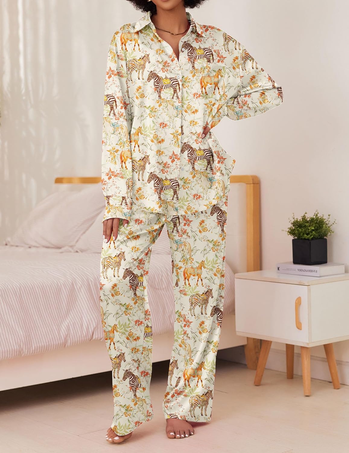 Cream satin pajama set with colorful animal print, button-front shirt and long pants.
