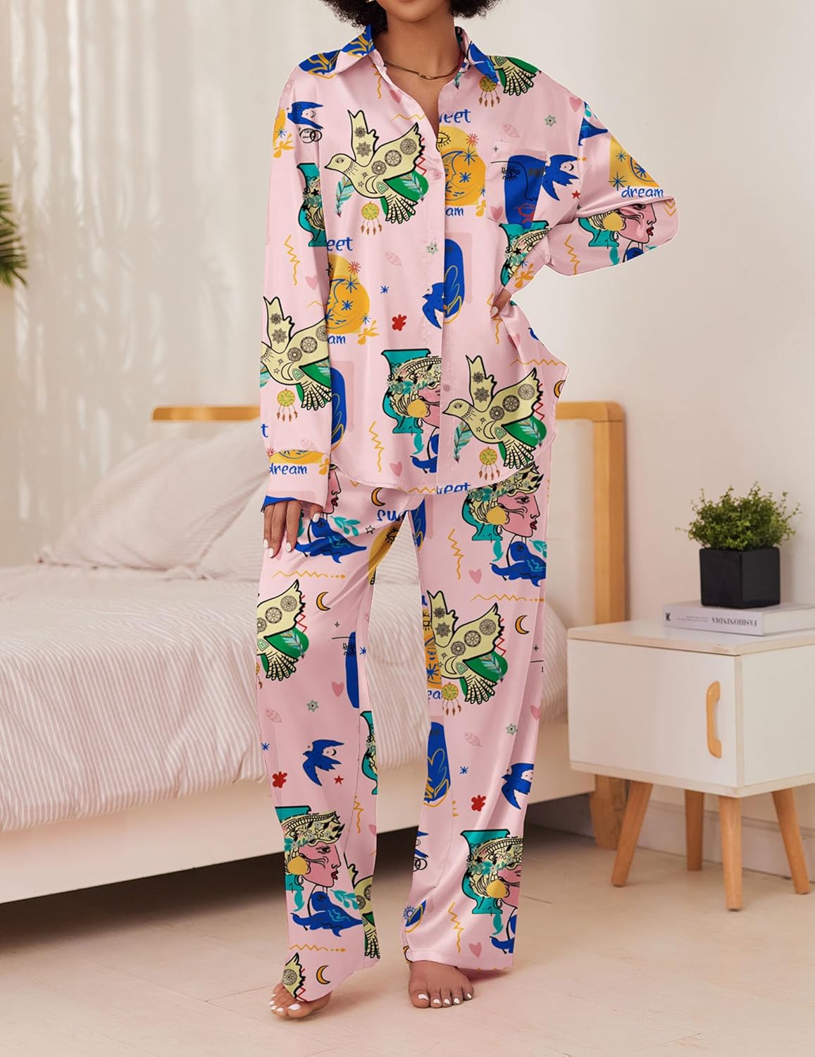 Pink cartoon print satin pajama set with long sleeves, front buttons, and long pants