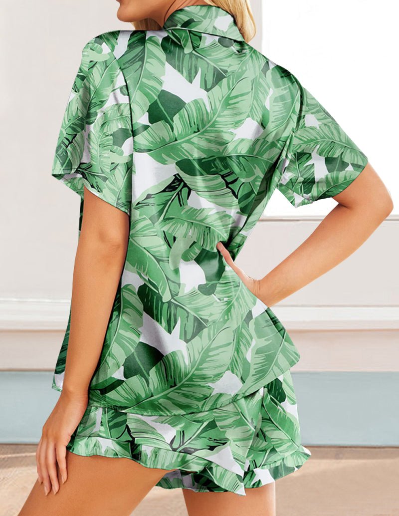 Green tropical leaf satin pajama set with short-sleeve top and tiered ruffle shorts