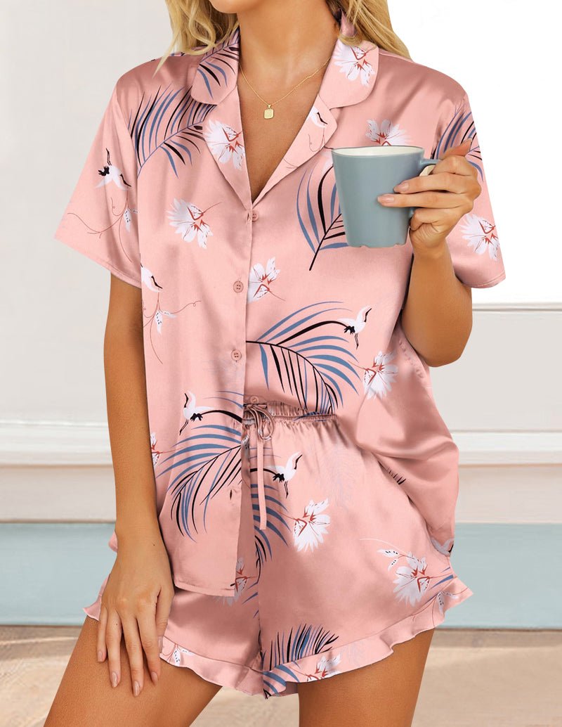 Pink tropical leaf satin pajama set with short-sleeve button shirt and matching shorts