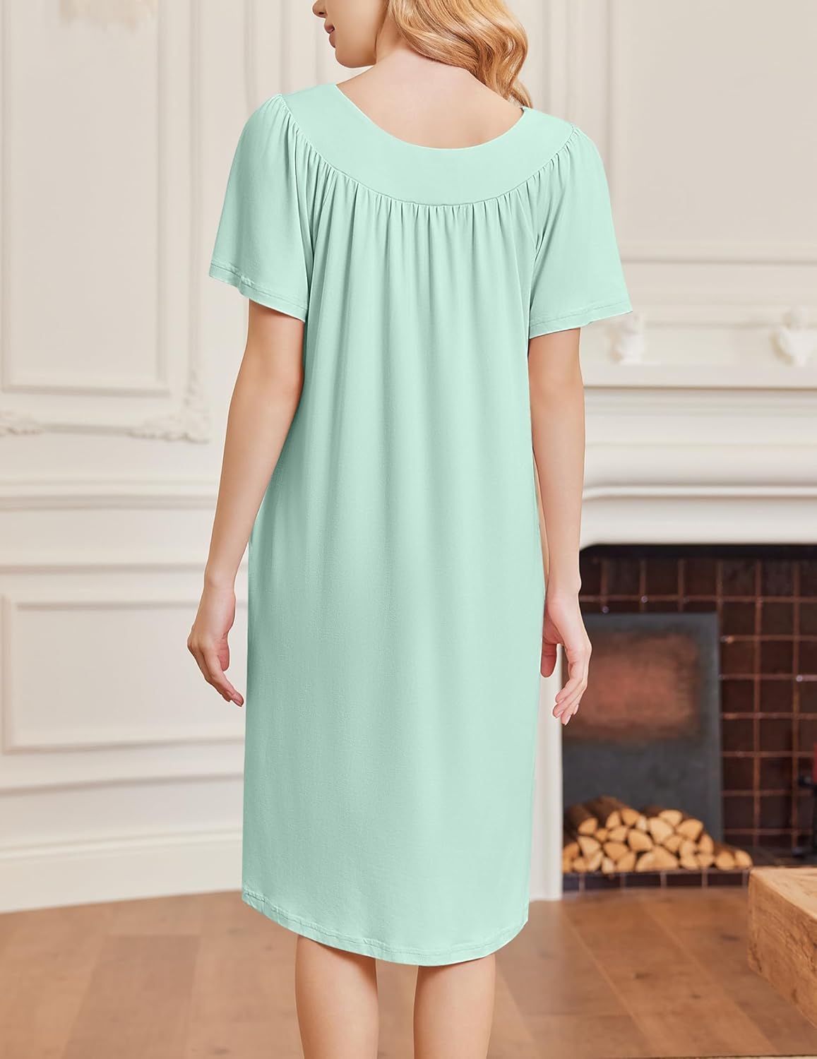 Back view of light green short-sleeve house dress, gathered yoke and midi length