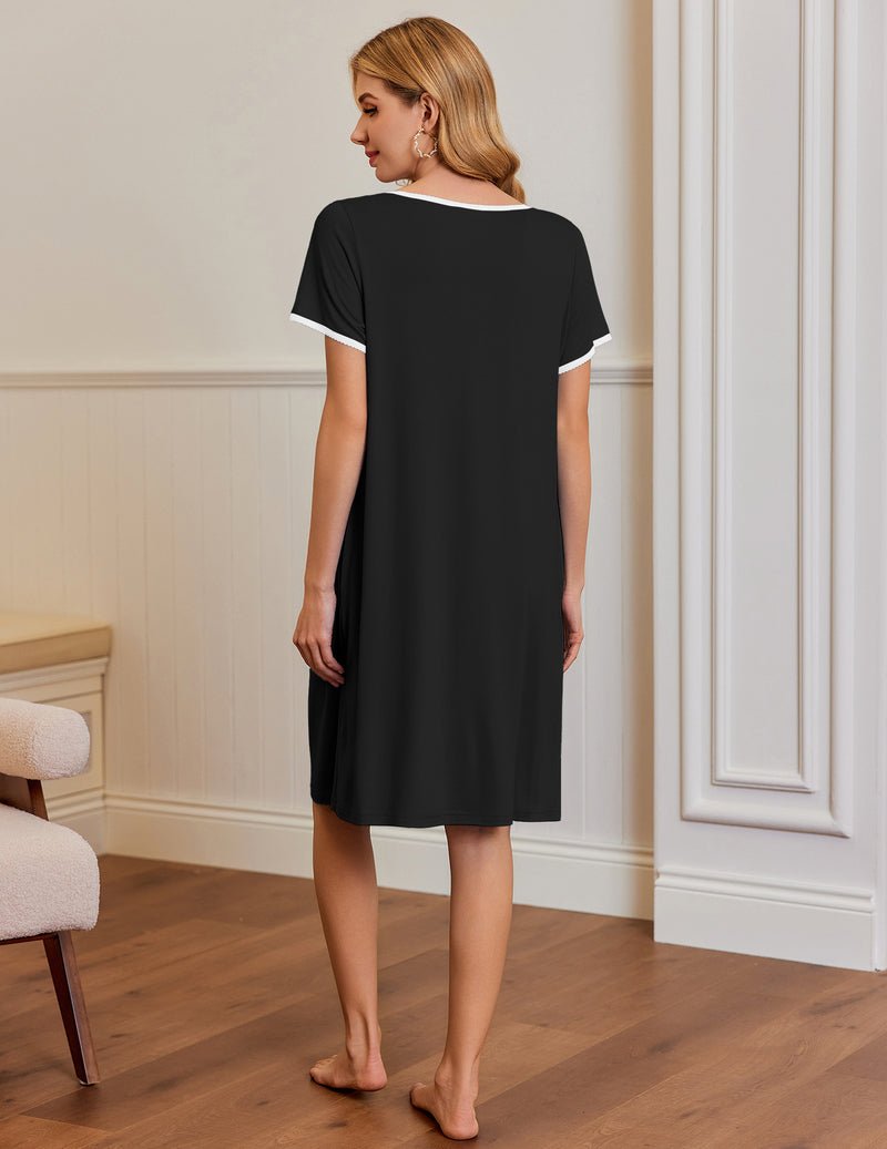 Black short-sleeve house dress with side pockets, pleated neckline and contrast trim