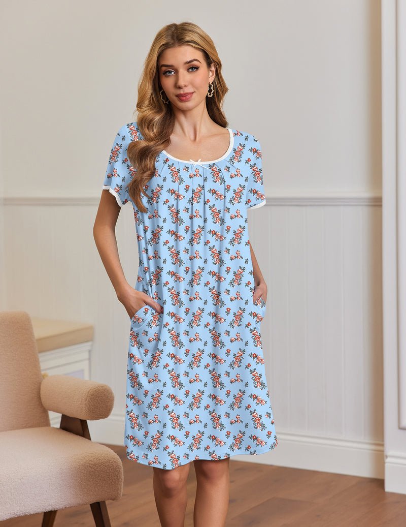 Light-blue short-sleeve house dress with side pockets and gathered neckline, floral print