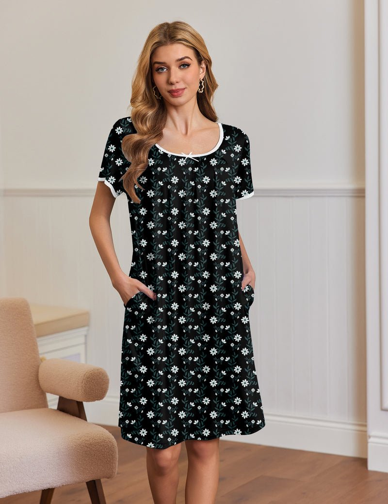 Black short-sleeve house dress with white floral print, side pockets and scalloped neckline trim