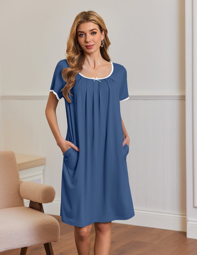 Blue short-sleeve house dress with side pockets, pleated bodice and white-trim neckline