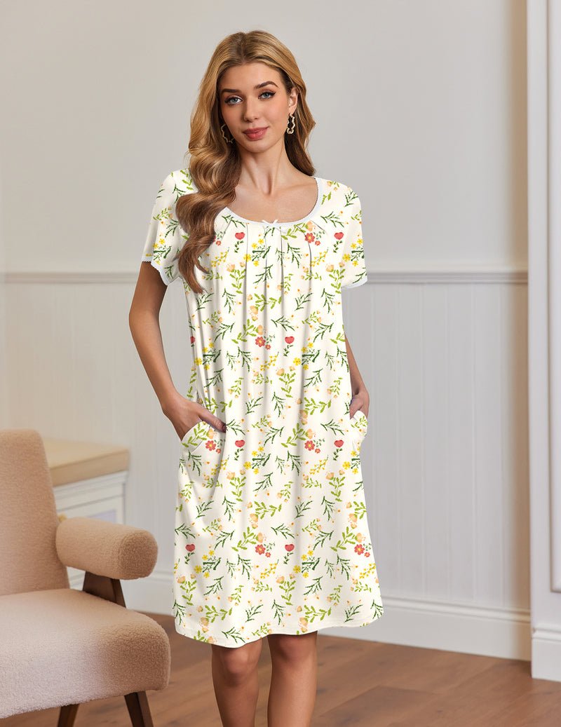 White short-sleeve house dress with green and red botanical print, side pockets and trim neckline