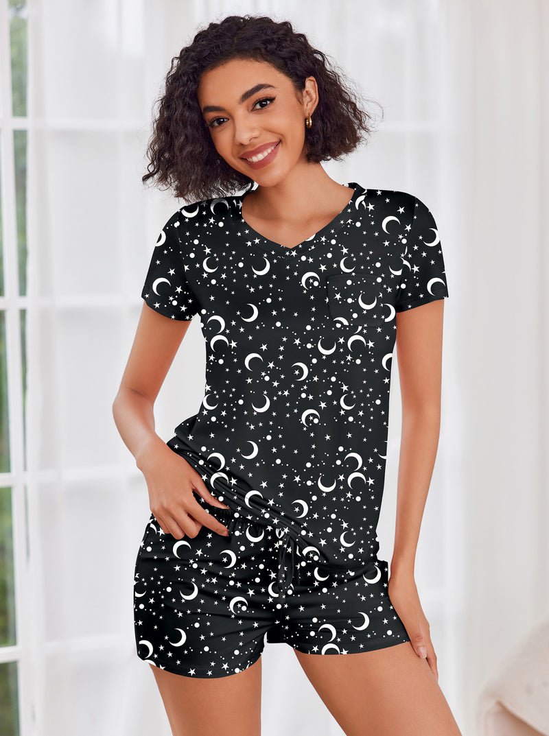 Black short-sleeve pajama set with moon-and-star print top and matching drawstring shorts