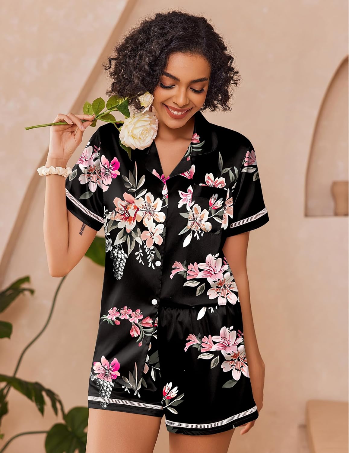 Black satin floral pajama set with button-up shirt and matching shorts, pink flowers