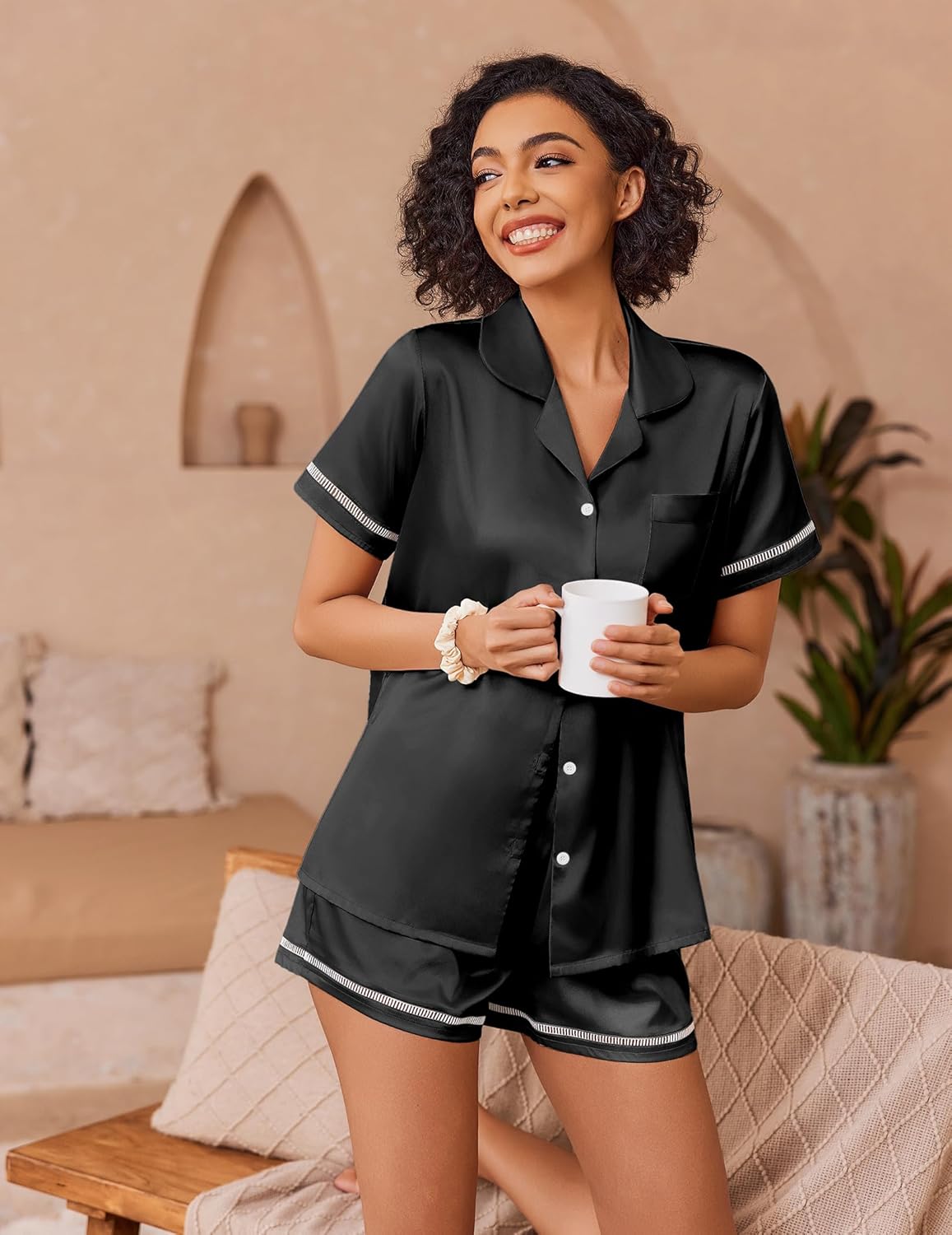 Black satin pajama set with button-up short sleeves and matching shorts, contrast trim