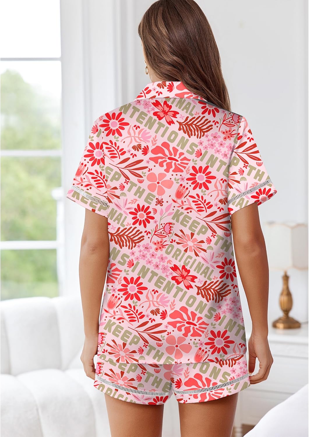 Pink floral satin pajama set with text pattern, short-sleeve top and matching shorts, back view