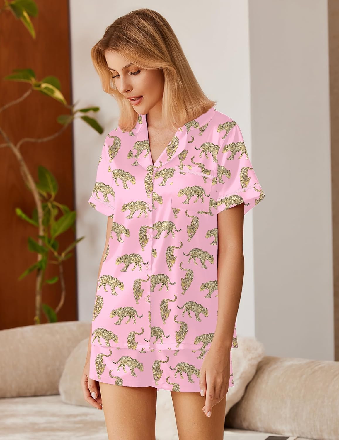 Pink satin lounge set with repeating animal print, button-down top and matching shorts