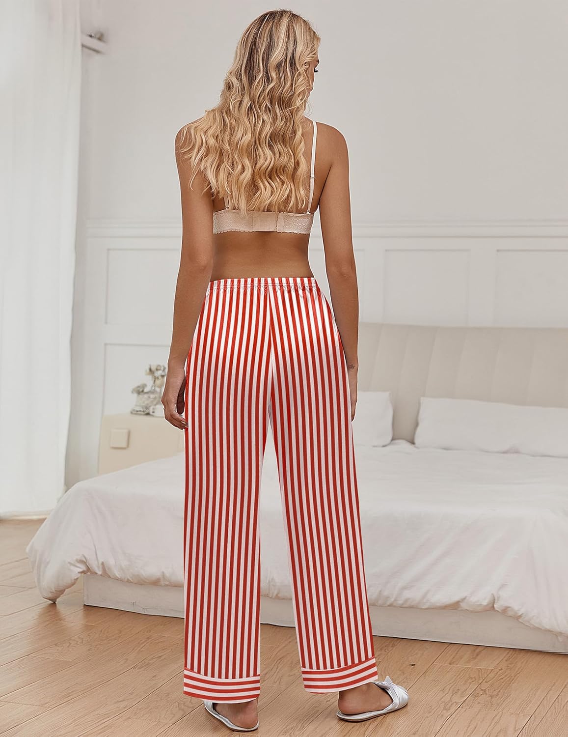 Silk satin pajama pants with red-and-white vertical stripes, elastic waist, wide leg