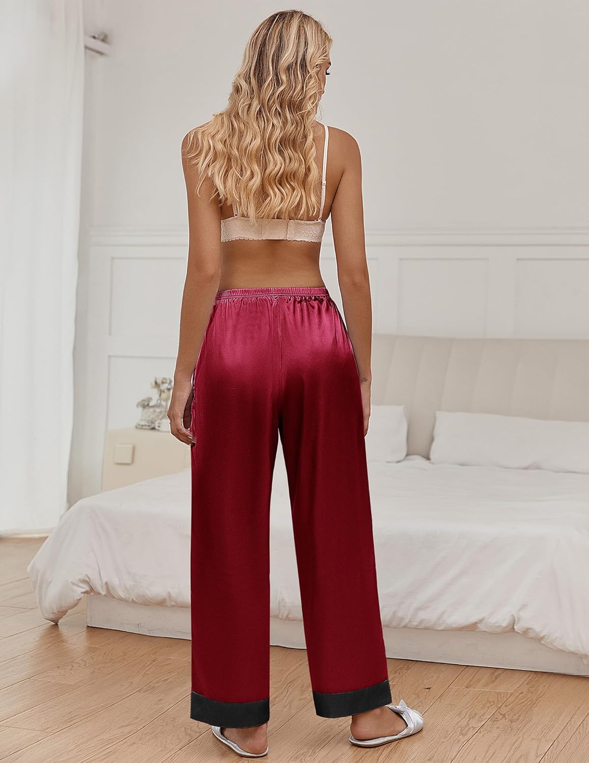 Silk satin pajama pants in wine-red with elastic waistband and dark cuffs