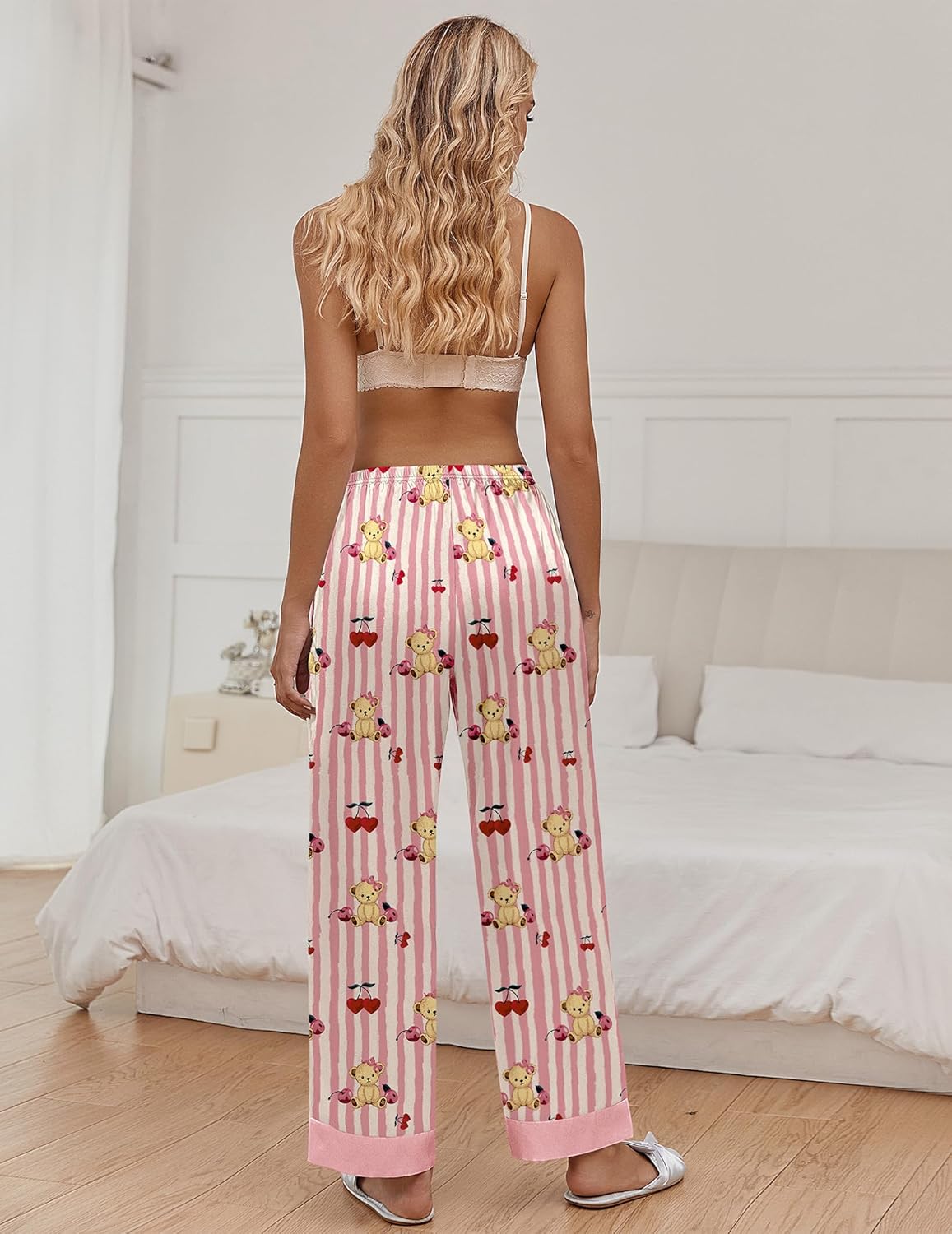 Pink striped pajama pants with teddy bear motif and bows, elastic waist, full length