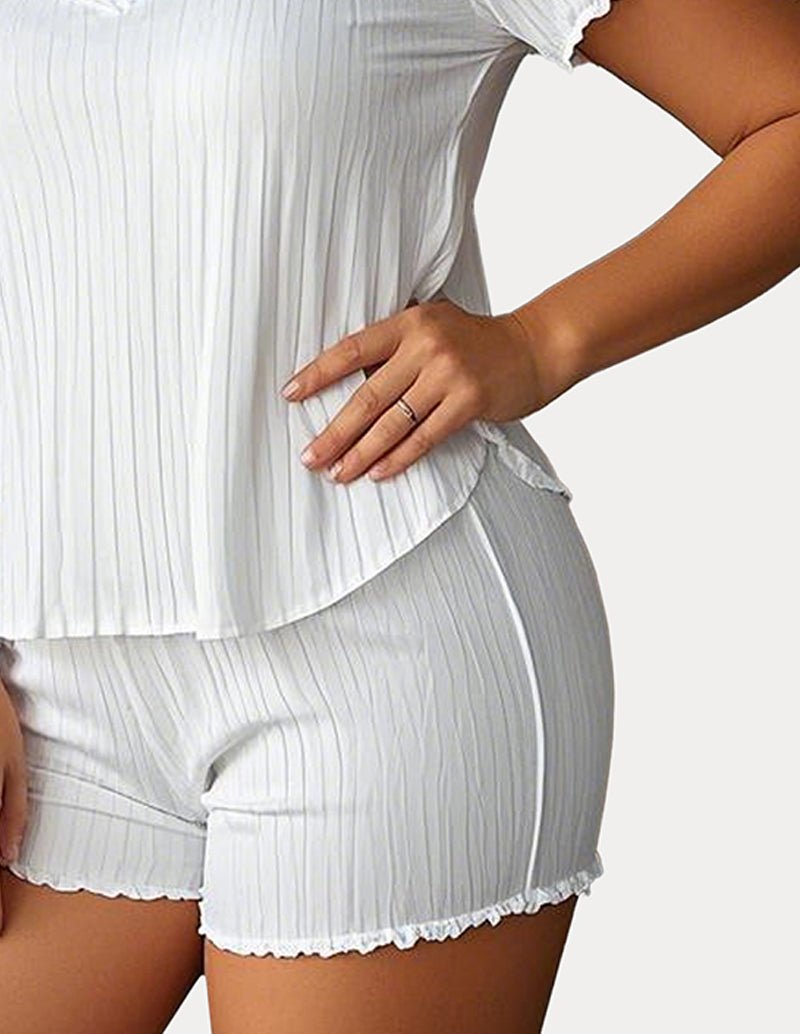 White textured pajama shorts and short-sleeve V-neck top with scalloped trim