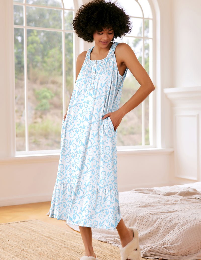 Sleeveless nightdress with pockets, light blue patterned print, button front and ruffled neckline