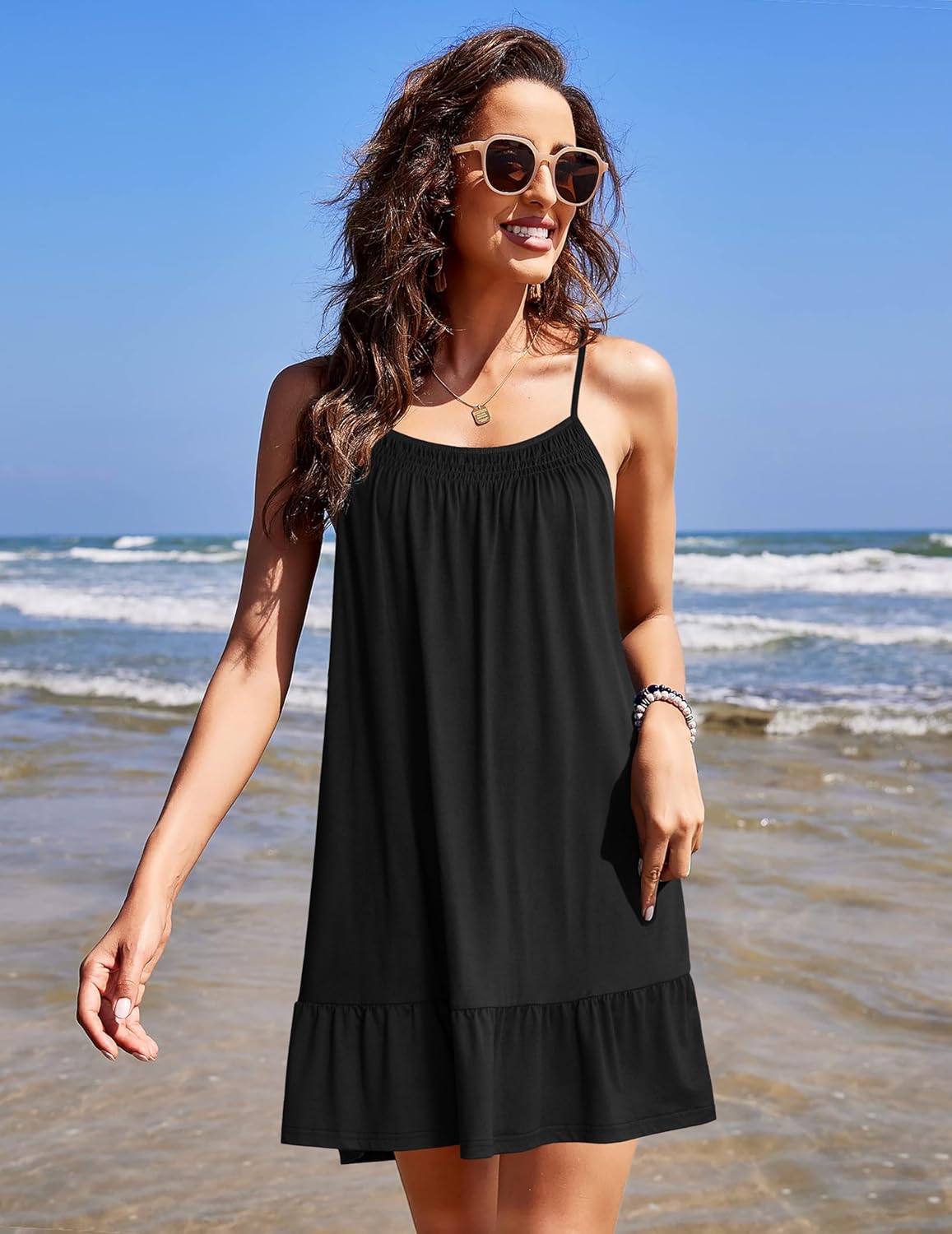 Sleeveless black night chemise dress with thin straps and tiered ruffle hem
