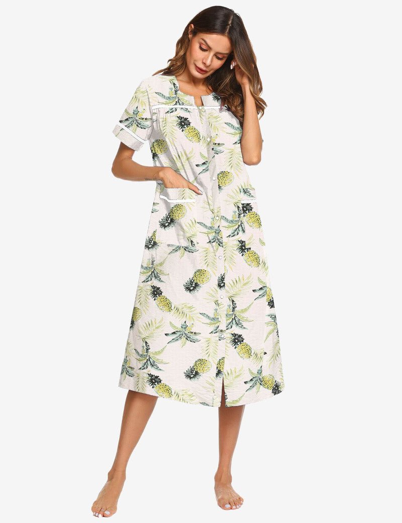 White cotton housecoat nightgown with green and yellow leaf print, short sleeves, pockets