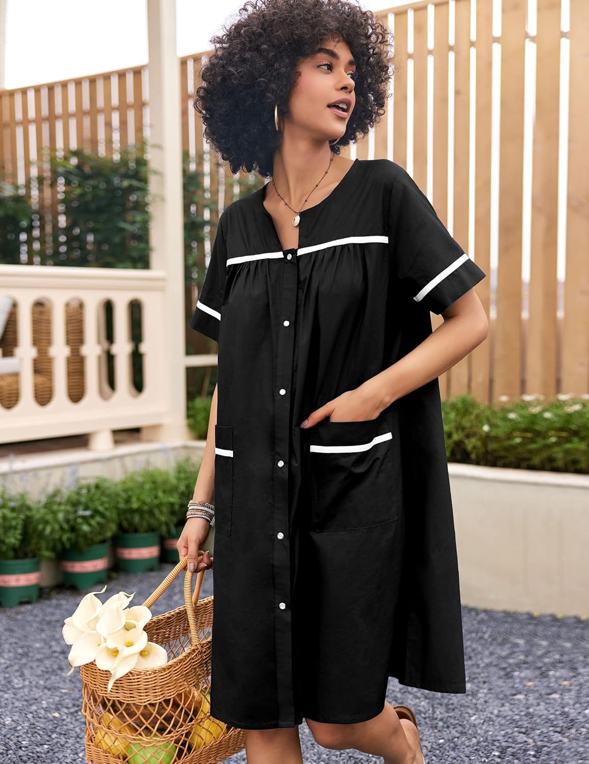 Black cotton snap-front house dress with chest placket and side pockets