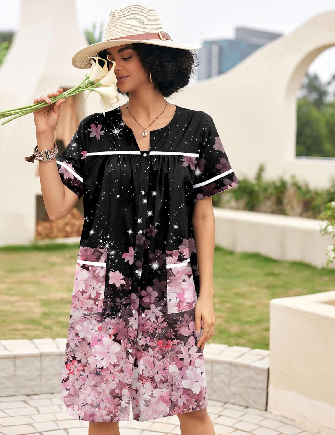 Black cotton snap-front house dress with pink floral print and white-trim accents