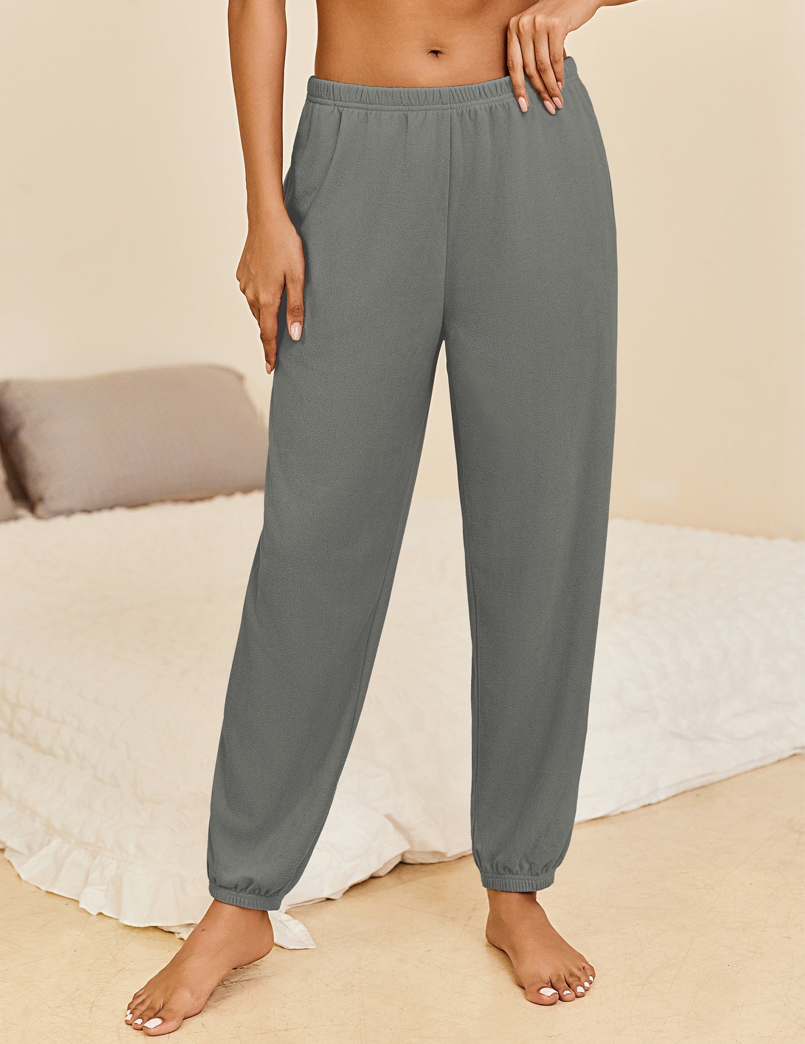 Dark grey lounge pants with elastic waistband and cuffed ankle hems, relaxed fit