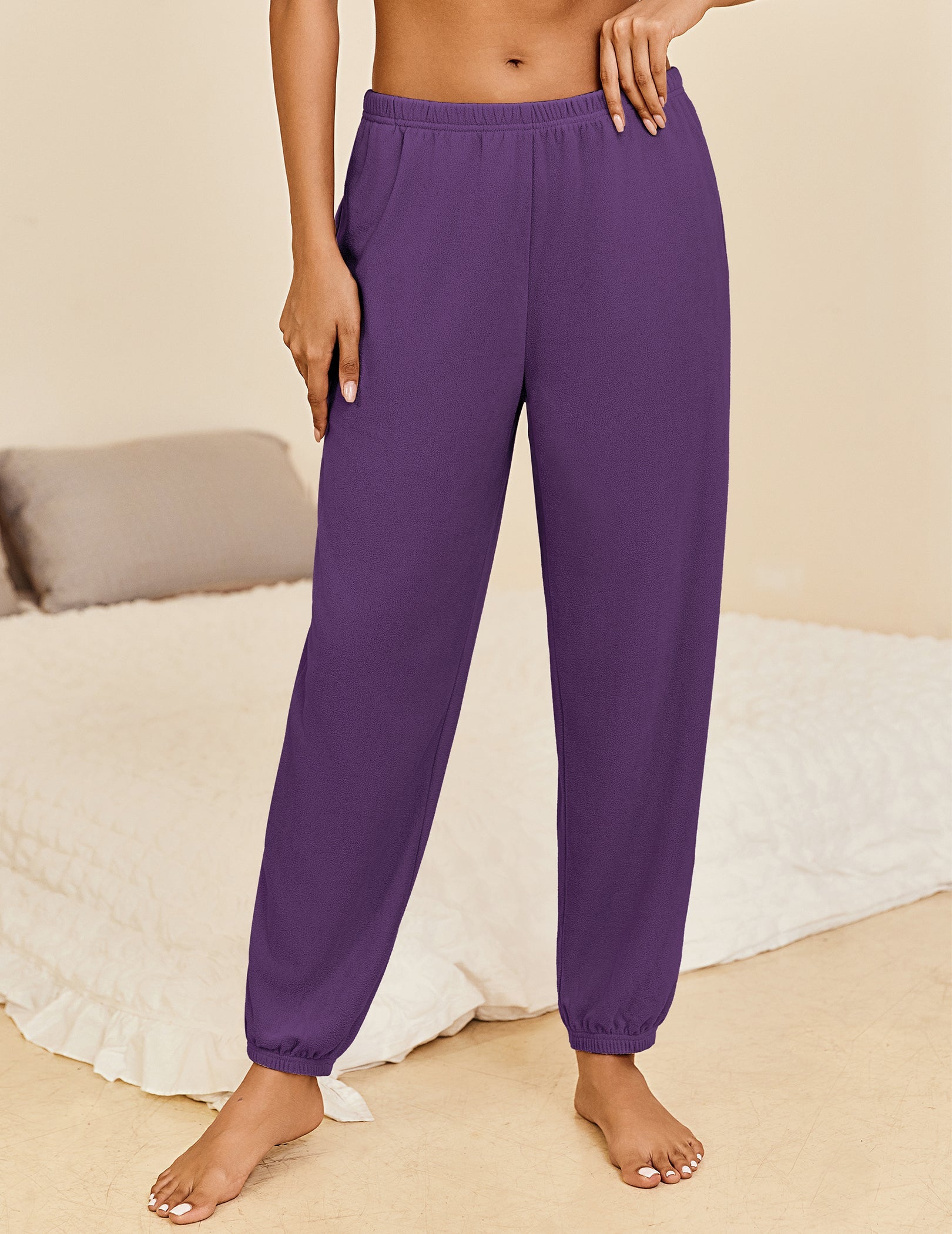 Purple lounge pants with elastic waistband and cuffed ankle hems, relaxed fit