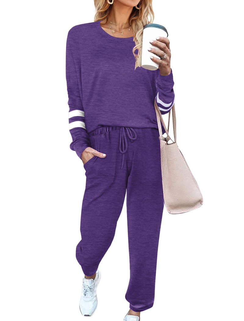 Purple pajama set with long sleeves, striped cuffs, and relaxed drawstring pants