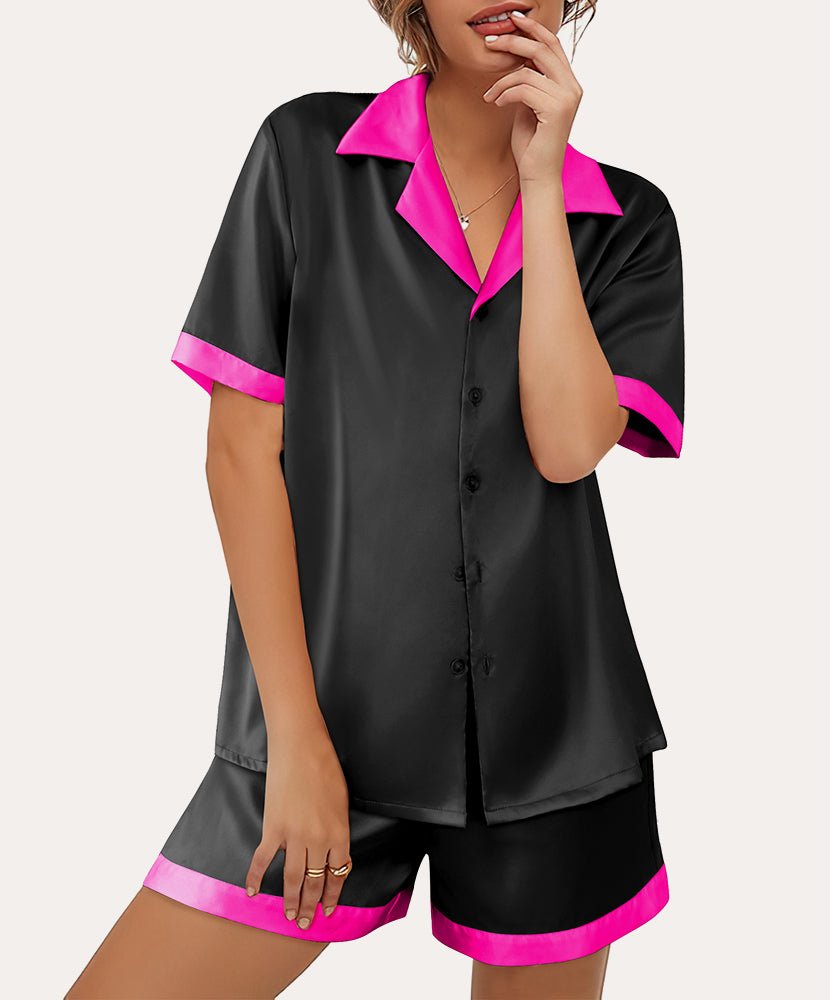 Black satin pajama top with bright pink/red collar trim and matching shorts, button front.