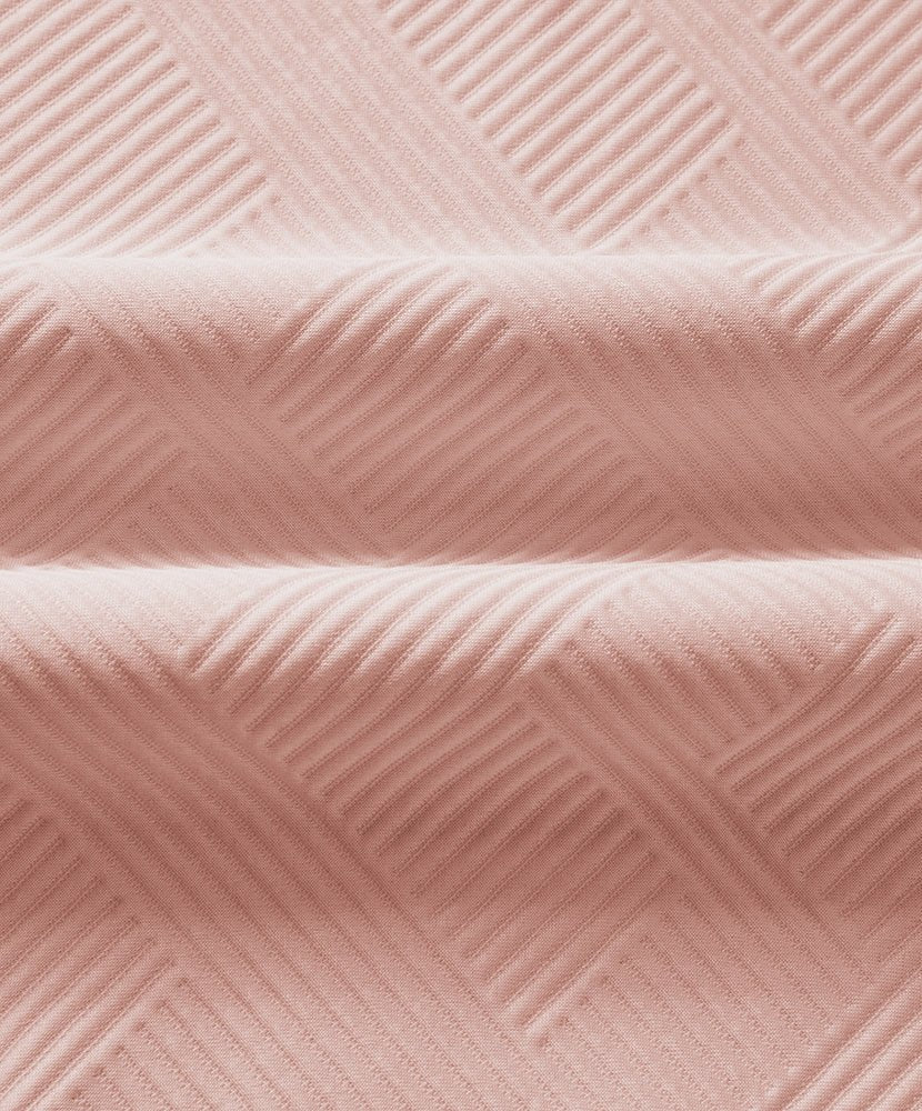Pink textured knit fabric with subtle diagonal ridges