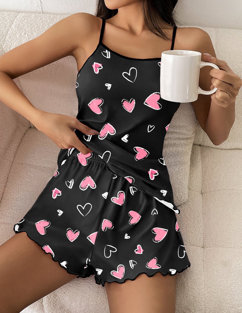 Close-up: black cami pajama set with pink hearts, spaghetti straps and gathered skirt