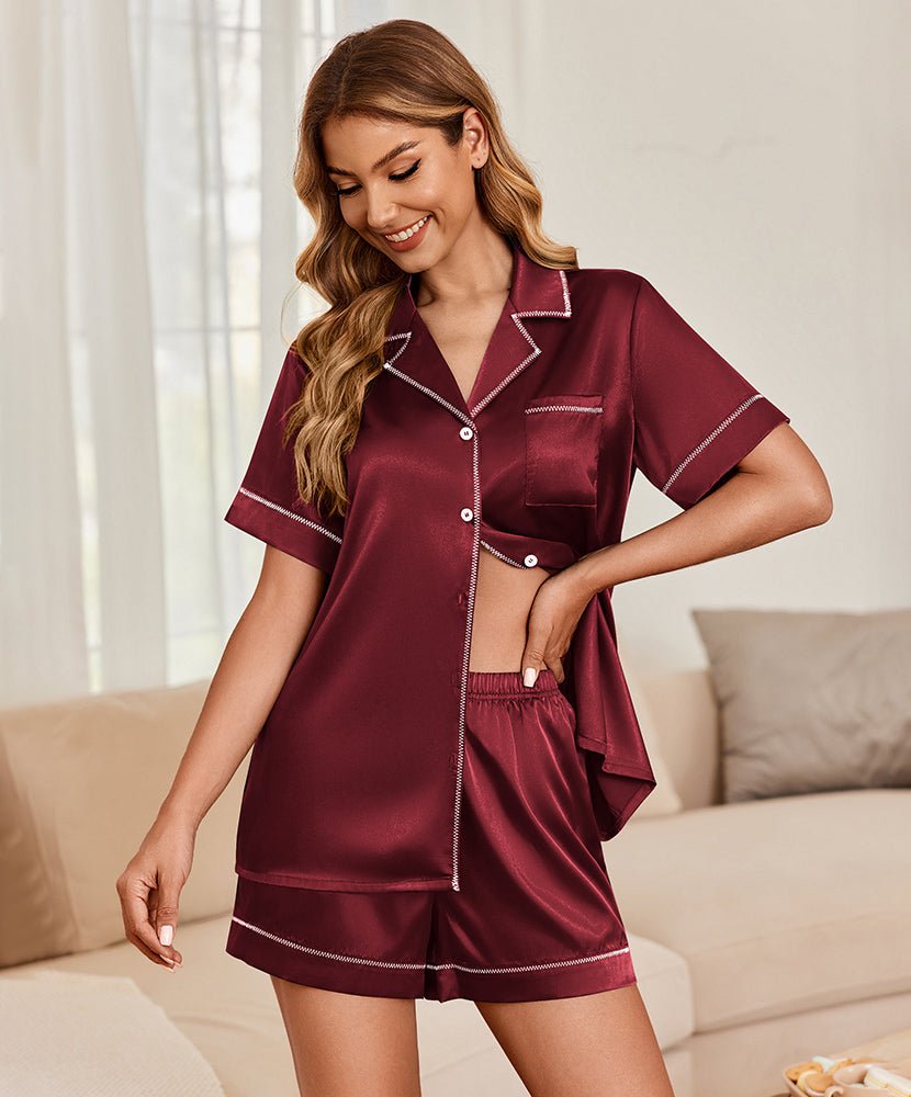 Burgundy satin pajama set with contrast trim, short-sleeve button top and matching shorts