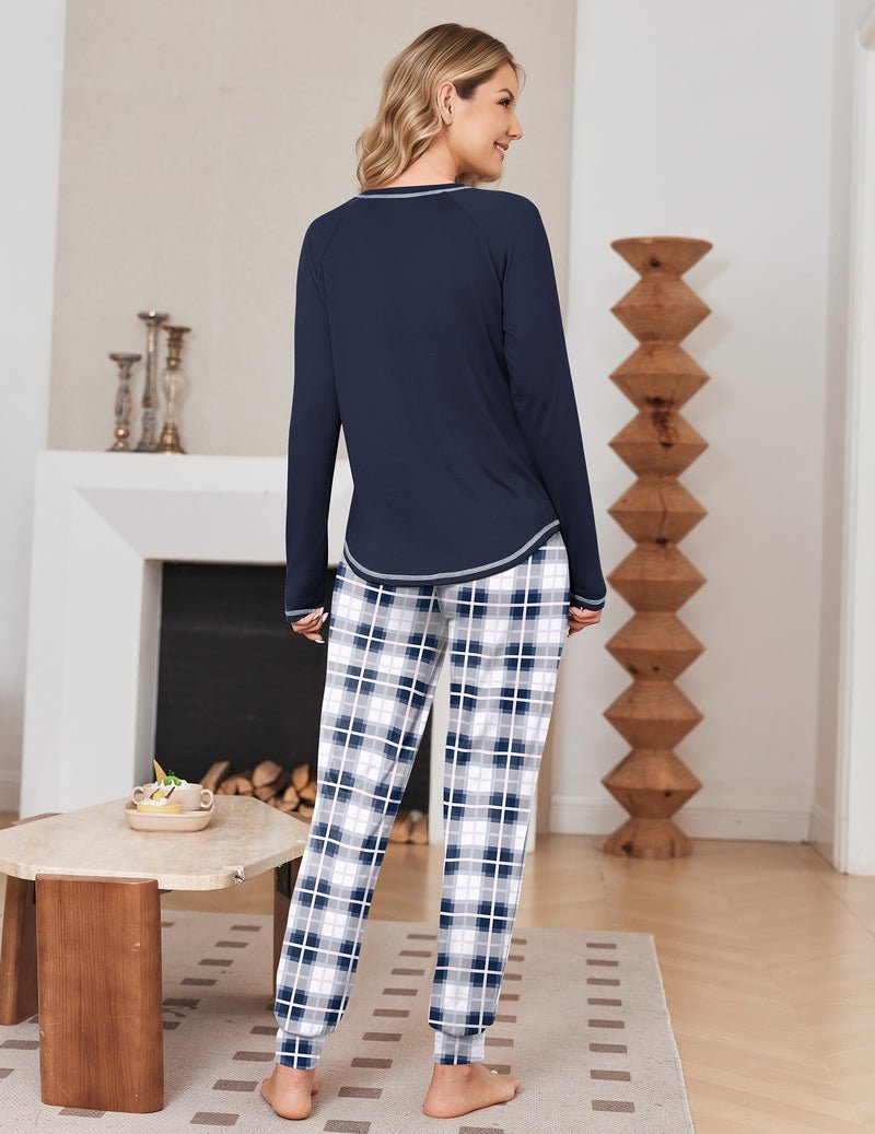Back view: navy long-sleeve pajama top with blue plaid jogger pants, contrast trim