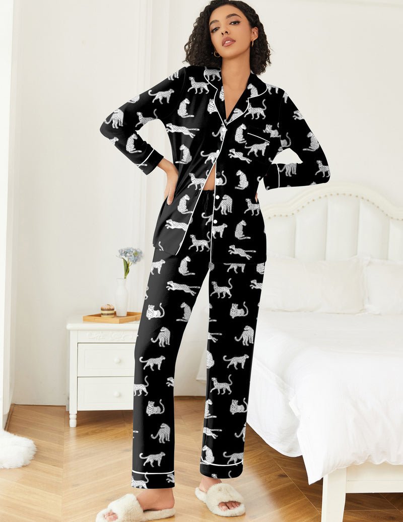 Black teddy pajama set with white dog-like figure print; button-front top and long pants.