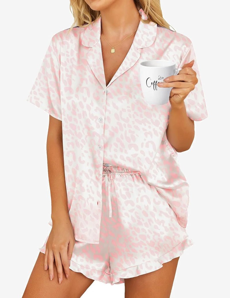 Satin pajama set in white with pink leopard print, collared button-up and drawstring shorts
