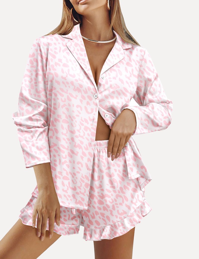 Satin pajama set with button-front long sleeves and ruffled pink leopard-print shorts.
